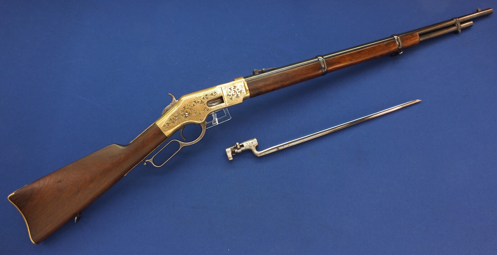 A fine antique American L.D. Nimschke Engraved Winchester Model 1866 Yellow Boy Musket with original Bayonet. 44 Henry centerfire caliber, 27 inch barrel. Length 118cm. In very good condition. Price on request