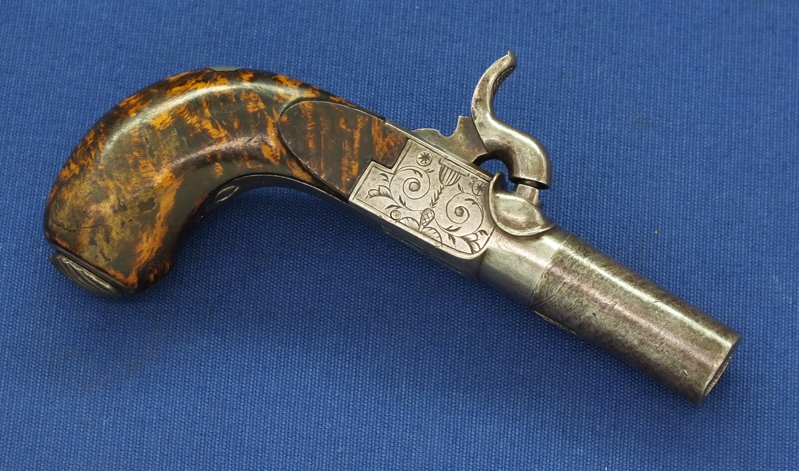 A fine antique Belgian circa 1850 Box-lock percussion Pistol with fine Root Walnut butt with unused Silver escutcheon and hinged lid with space for caps. Caliber 12mm, length 15,5cm. In very good condition. Price 750 euro.