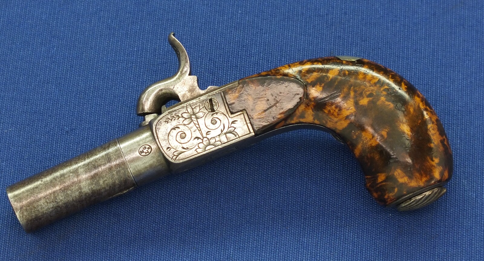 A fine antique Belgian circa 1850 Box-lock percussion Pistol with fine Root Walnut butt with unused Silver escutcheon and hinged lid with space for caps. Caliber 12mm, length 15,5cm. In very good condition. Price 750 euro.