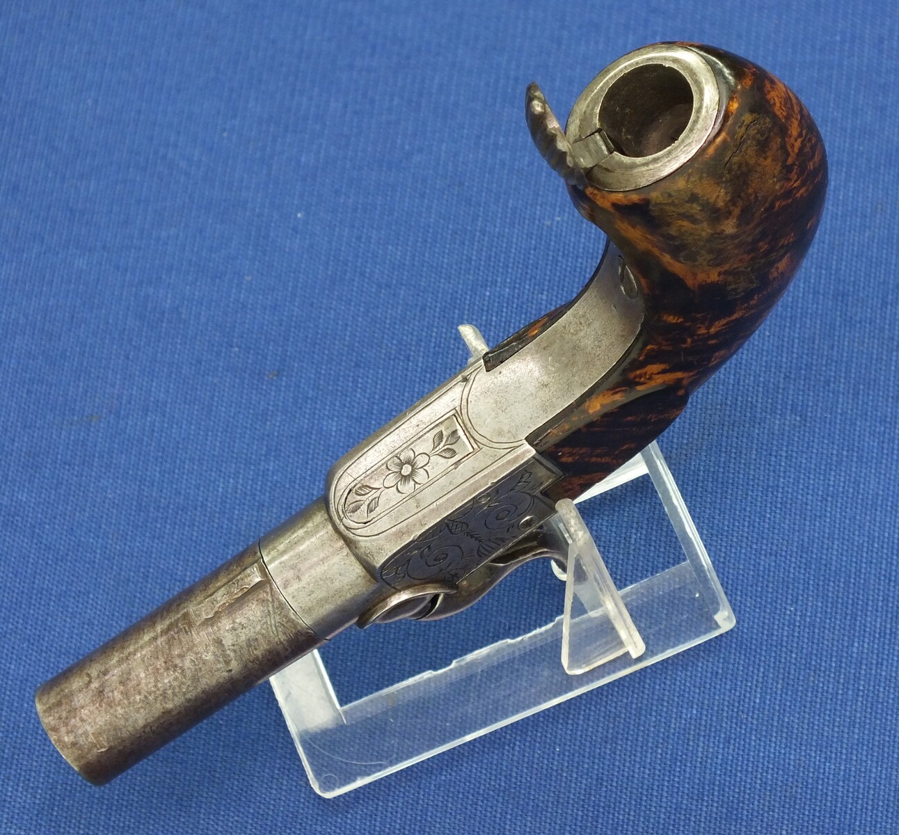 A fine antique Belgian circa 1850 Box-lock percussion Pistol with fine Root Walnut butt with unused Silver escutcheon and hinged lid with space for caps. Caliber 12mm, length 15,5cm. In very good condition. Price 750 euro.