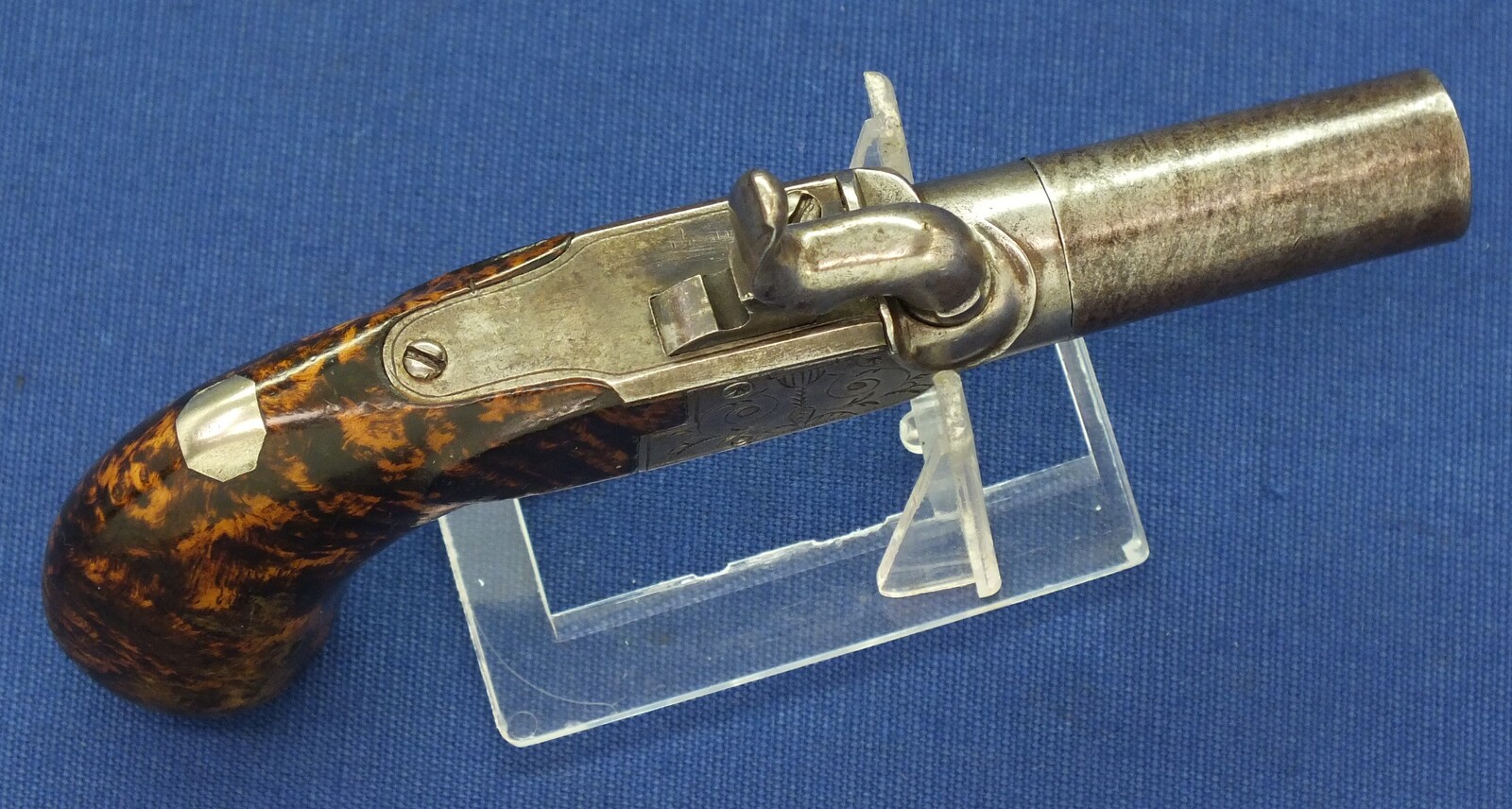 A fine antique Belgian circa 1850 Box-lock percussion Pistol with fine Root Walnut butt with unused Silver escutcheon and hinged lid with space for caps. Caliber 12mm, length 15,5cm. In very good condition. Price 750 euro.