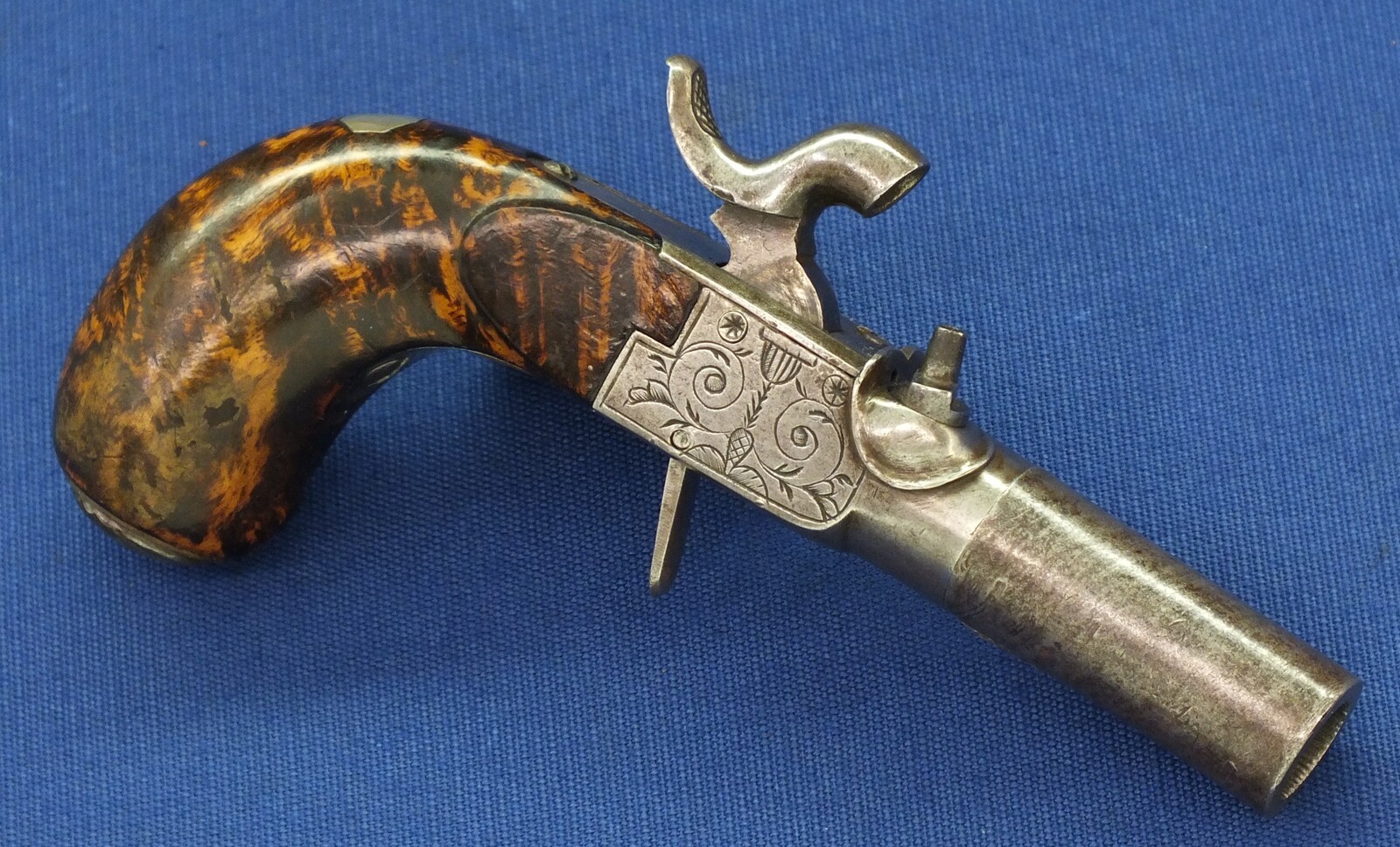 A fine antique Belgian circa 1850 Box-lock percussion Pistol with fine Root Walnut butt with unused Silver escutcheon and hinged lid with space for caps. Caliber 12mm, length 15,5cm. In very good condition. Price 750 euro.