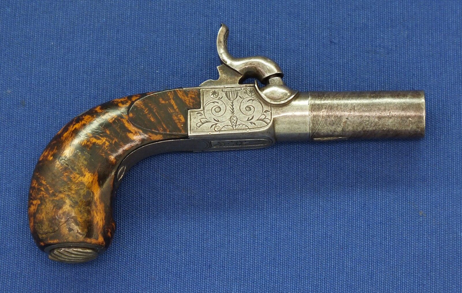 A fine antique Belgian circa 1850 Box-lock percussion Pistol with fine Root Walnut butt with unused Silver escutcheon and hinged lid with space for caps. Caliber 12mm, length 15,5cm. In very good condition. Price 750 euro.