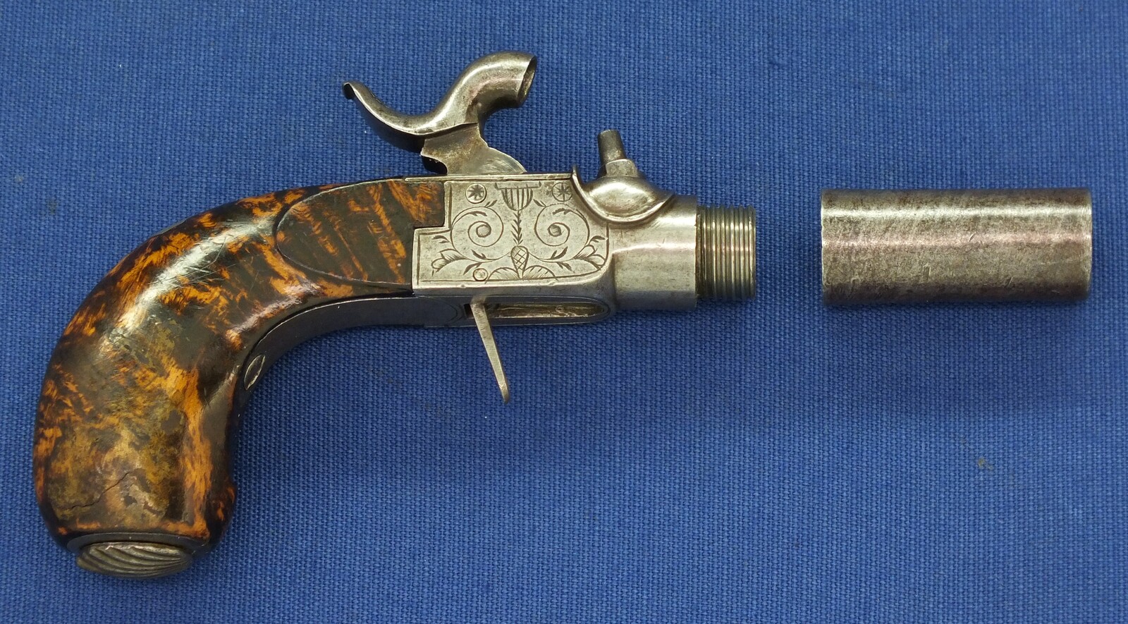 A fine antique Belgian circa 1850 Box-lock percussion Pistol with fine Root Walnut butt with unused Silver escutcheon and hinged lid with space for caps. Caliber 12mm, length 15,5cm. In very good condition. Price 750 euro.