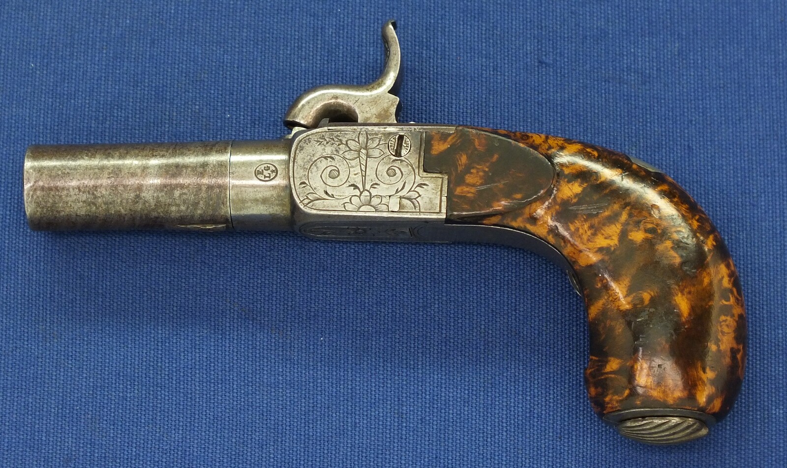 A fine antique Belgian circa 1850 Box-lock percussion Pistol with fine Root Walnut butt with unused Silver escutcheon and hinged lid with space for caps. Caliber 12mm, length 15,5cm. In very good condition. Price 750 euro.