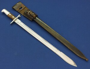 A Swiss Model 1914 Pioneer Bayonet with metal scabbard and leather frog, Made by Waffenfabrik Neuhausen. For Rifle: Schmidt-Rubin Model 1911 Carbine, K31. SN696449. Length 64cm. In very good condition.