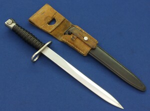 A Swiss model 1957 bayonet for Sig Sturmgewehr/Assault rifle made by Wenger with Leather frog. Length 38cm. In very good condition. 