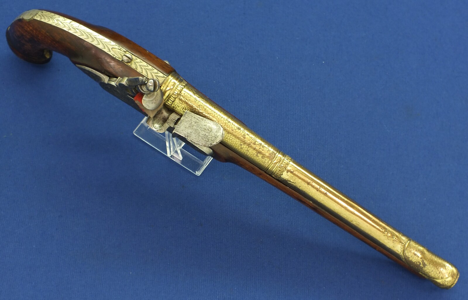 An antique 19th century Eastern Flintlock pistol with decorative gilded Brass Cannon barrel with Fish/Sea monster shaped Muzzle. Length 44cm. Caliber 14mm. In very good condition. Price 1.350 euro