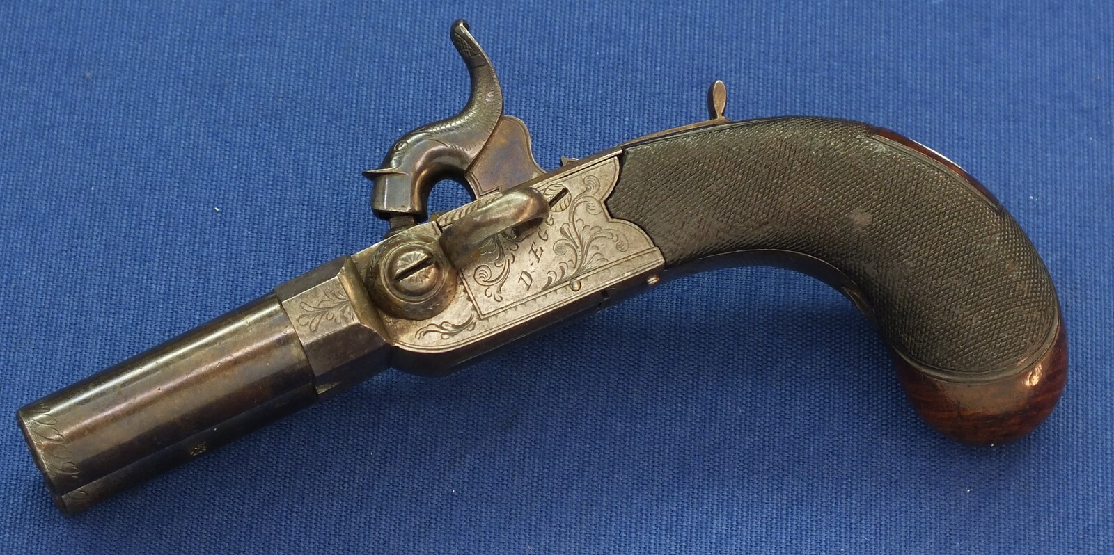 An antique English Box-Lock tap-action side by side Perussion Pistol with thumbpiece safety catch by Durs Egg London. Caliber 9,5mm. Length 16cm. In very good condition. Price 950 euro