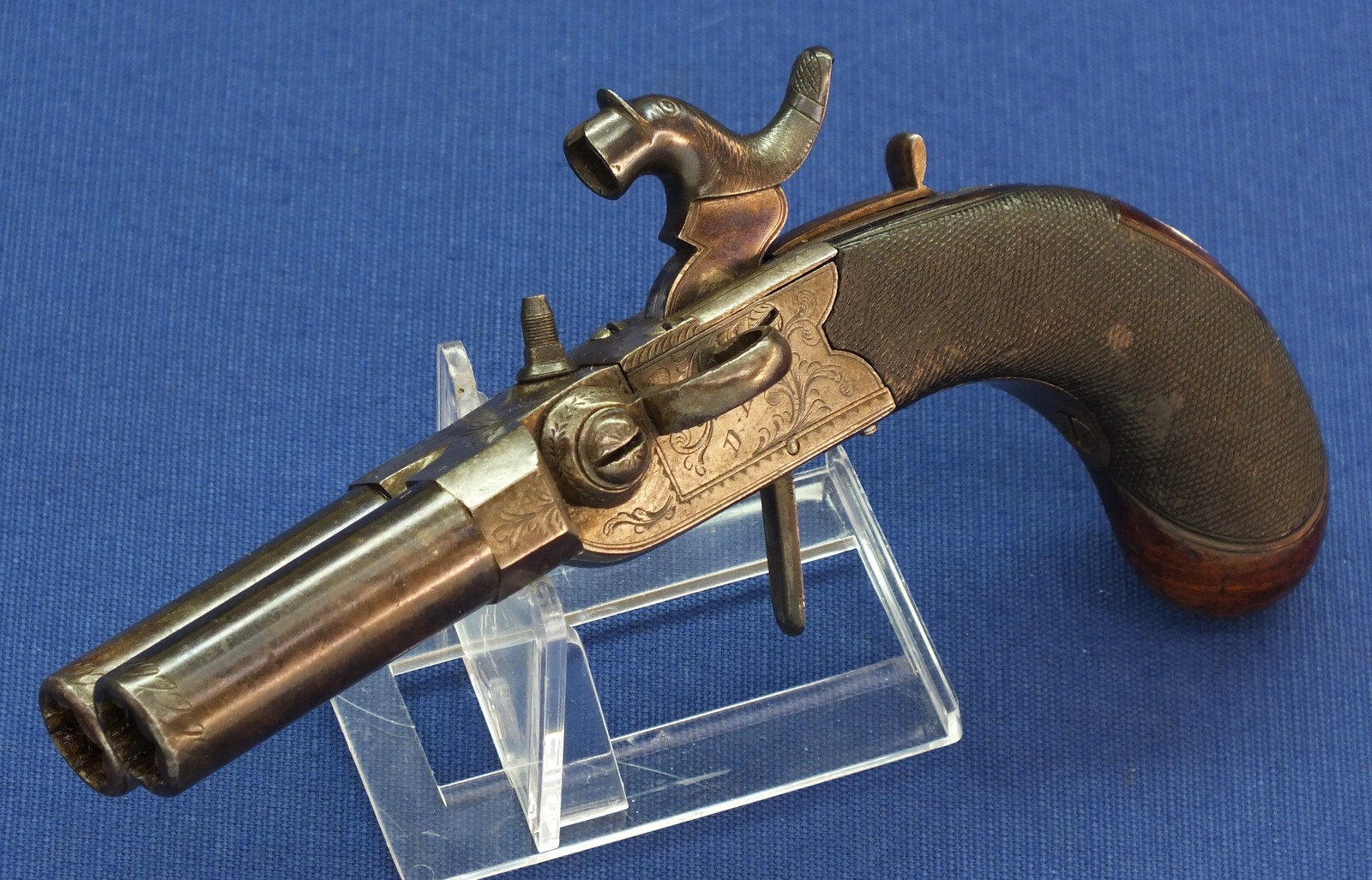 An antique English Box-Lock tap-action side by side Perussion Pistol with thumbpiece safety catch by Durs Egg London. Caliber 9,5mm. Length 16cm. In very good condition. Price 950 euro