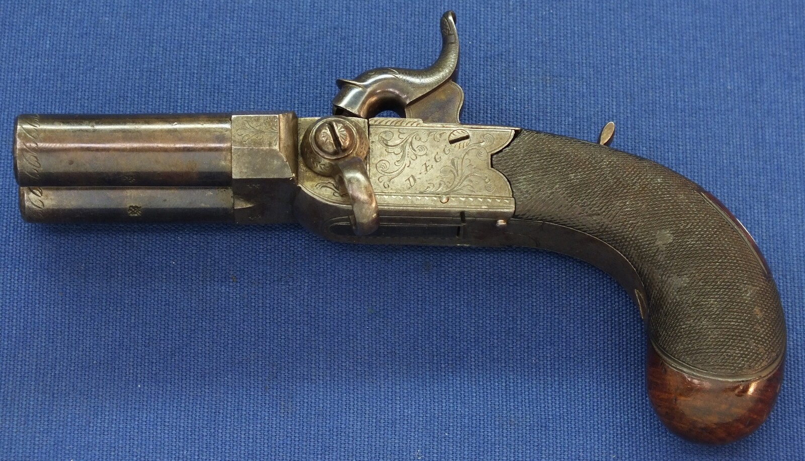 An antique English Box-Lock tap-action side by side Perussion Pistol with thumbpiece safety catch by Durs Egg London. Caliber 9,5mm. Length 16cm. In very good condition. Price 950 euro