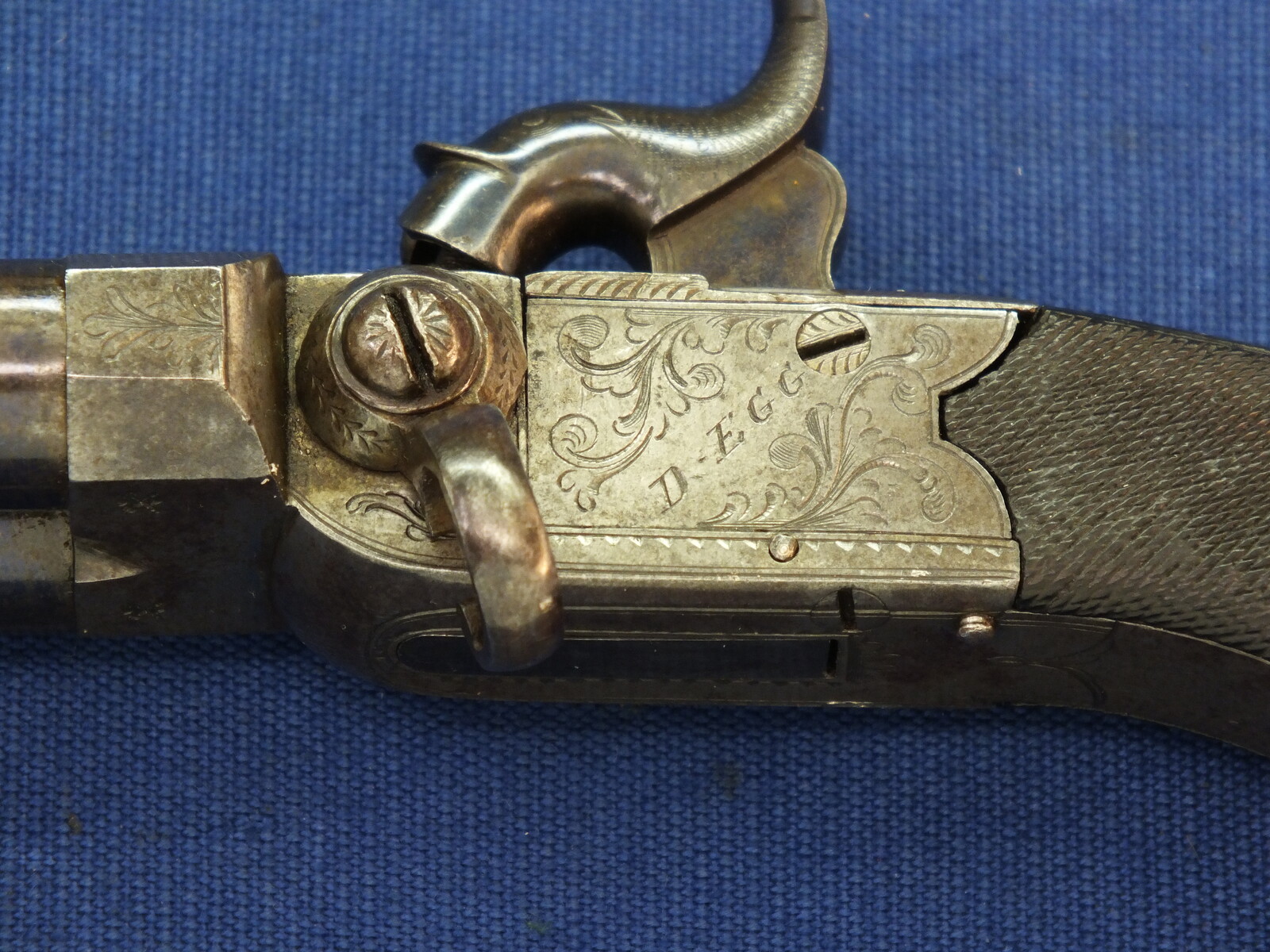 An antique English Box-Lock tap-action side by side Perussion Pistol with thumbpiece safety catch by Durs Egg London. Caliber 9,5mm. Length 16cm. In very good condition. Price 950 euro