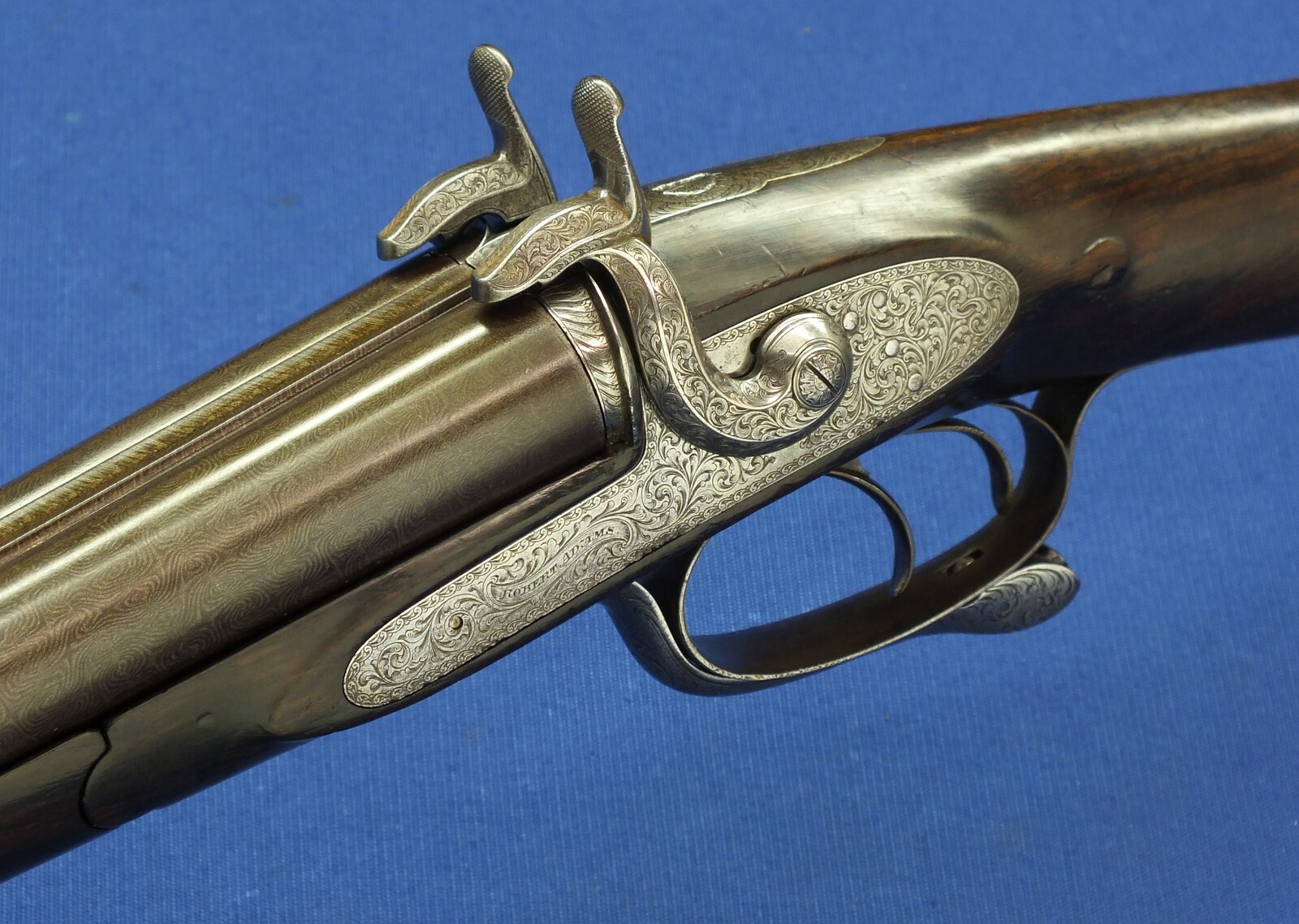 An antique English cased Double barreled Pinfire 12-Bore sporting gun by Robert Adams 76 King William Street London. Adams 1860 Patent No. 285. 30 inch damascus barrels. In good/very good condition. Price 895 euro