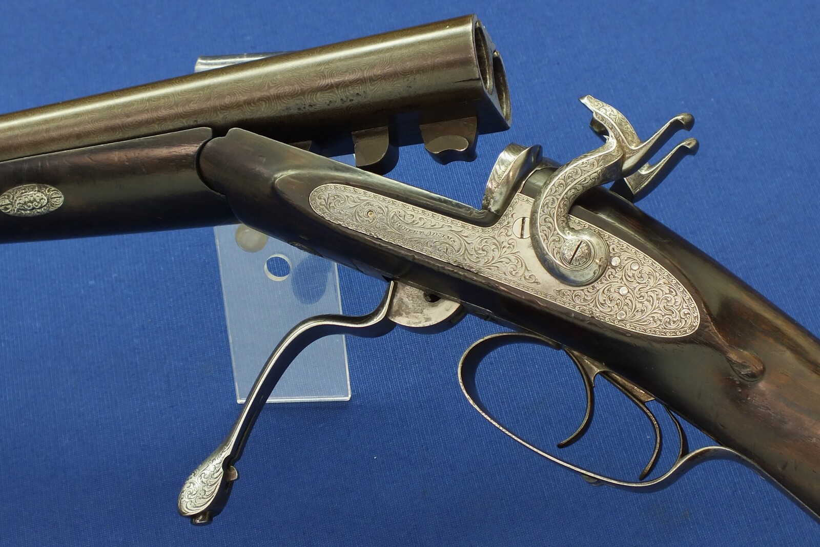 An antique English cased Double barreled Pinfire 12-Bore sporting gun by Robert Adams 76 King William Street London. Adams 1860 Patent No. 285. 30 inch damascus barrels. In good/very good condition. Price 895 euro